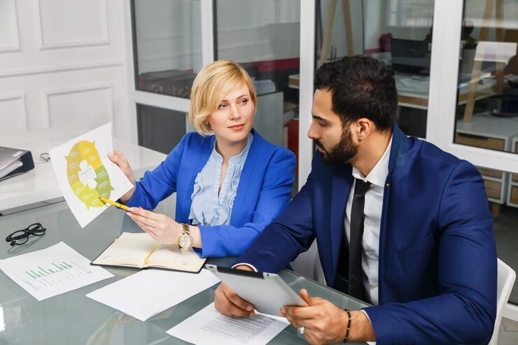 Female advisor explaining property risk charts to male client during due diligence consultation